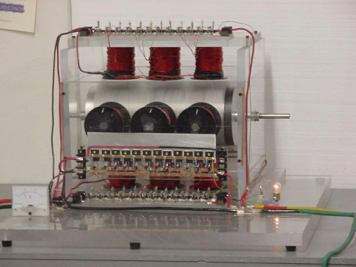 An electromagnetic induction device with coils and wires, viewed from the front